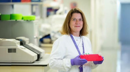 doctor in a lab coat holding test tubes pancreatic cancer uk winter appeal