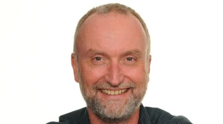 David Rose white background smiling at the camera